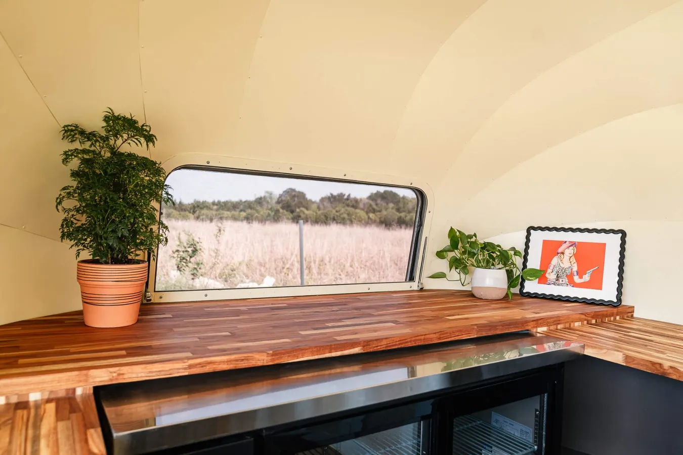 Service area counter with butcher block top and fridge